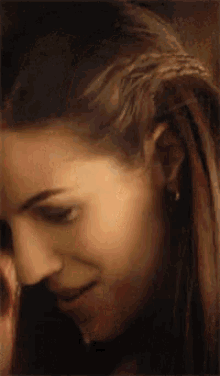 a close up of a woman 's face with long brown hair