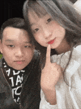 a man and a girl are posing for a picture and the girl is wearing a shirt that says 1ac