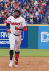 a baseball player for the indians is running towards the bases