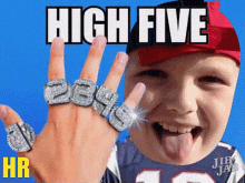 a young boy with rings on his fingers and the words high five hr