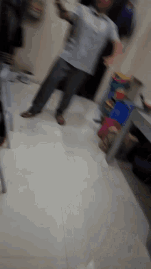 a blurry picture of a man standing on a tiled floor