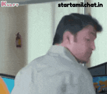 a man is standing in front of a window with the words starttamilchat.in written on the bottom