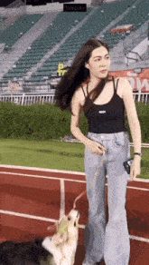a woman is walking a dog on a leash