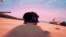 a video game character is crawling in the sand on a beach