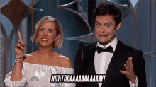 a man and a woman are standing next to each other and the woman is pointing up while the man says not today
