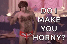 a shirtless man in british flag underwear is standing in front of a bed and asking do i make you horny ?
