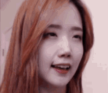 a close up of a woman with red hair making a funny face