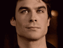 a close up of a man 's face with his eyes closed