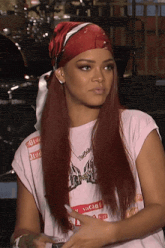 a woman with red hair is wearing a white shirt that says vacant on it