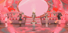 a girl with a crown on her head is standing on a stage with other girls