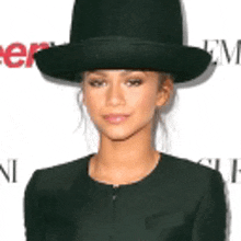 a woman wearing a top hat and a black jacket .