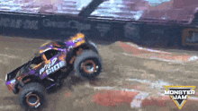 a monster jam advertisement shows a purple and orange monster truck