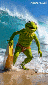 kermit the frog is on the beach holding a surfboard and smiling