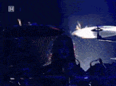 a man playing drums in front of a screen that has the letter rr on it