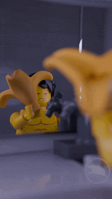 a lego figure looks at himself in a mirror