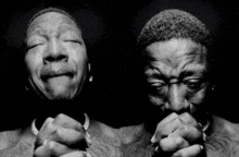 a black and white photo of a man with his eyes closed