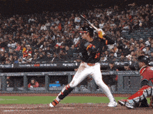 a baseball player with the number 51 on his jersey swings his bat