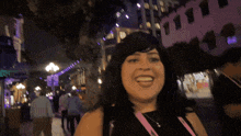 a woman with a lanyard around her neck that says ' i love you '