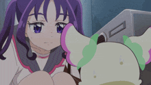 a girl with purple hair is sitting next to a toy