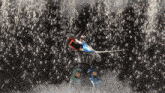 a robot is holding a sword in front of a crowd of sparks
