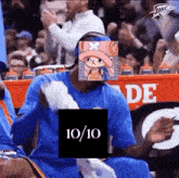 a basketball player with a picture of tony tony chopper on his face is sitting in the stands .