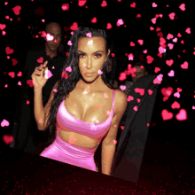 a woman in a pink dress with hearts falling around her