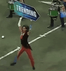 a woman holding a sign that says trending
