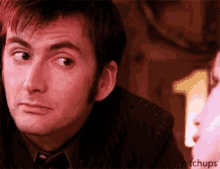 a close up of a man 's face with the words hitchups on the bottom right corner