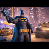 a man in a batman costume holds a gun