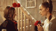 two girls are standing next to each other with one wearing a headband with pom poms and the word " rescue " on it