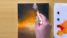 a person is painting on a canvas with the words made in animatica on the bottom right
