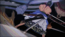 a man in a kimono is holding a sword in his hand in a dark room .