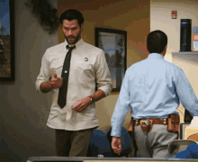 a man wearing a white shirt and tie has a badge on his chest that says ' i love you '