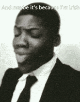 a man in a suit and tie is making a funny face and maybe it 's because he 's irish .