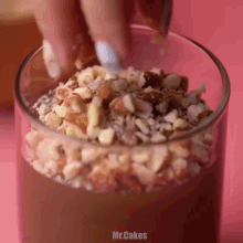 a close up of a glass with nuts on top and the words mr.cakes below