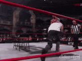 a man in a white shirt is in a wrestling ring that says aew