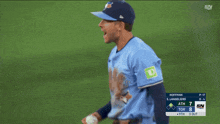 a blue jays player throws a ball during a baseball game