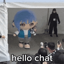a group of people are taking pictures of a mascot that says hello chat on the bottom