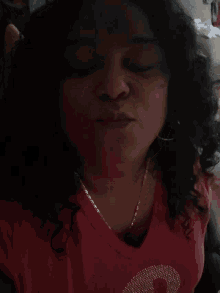 a woman wearing a red shirt with the word dolce on the front