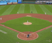 a baseball player is sliding into home plate while a referee looks on