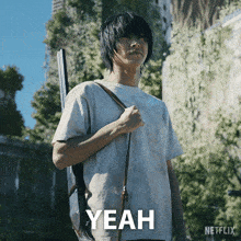 a man is holding a gun and the word yeah is on the screen