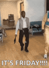 a man is dancing in a room with the words `` it 's friday ! '' written on the floor .