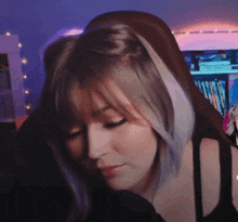 a close up of a woman 's face with a purple background