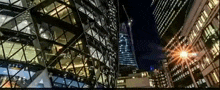 a city at night with a lot of tall buildings and a street light