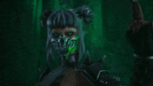 a woman wearing a mask with a green skull on it
