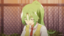 a girl with green hair and a red tie is standing in front of a chain link fence