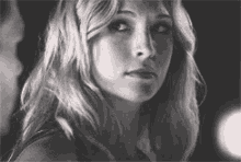 a black and white photo of a woman 's face .