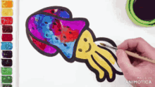 a person is painting a colorful squid with a brush ..