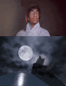 a man looks up at a full moon while a cat looks down at the water