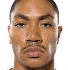 a man with a beard and mustache looks at the camera